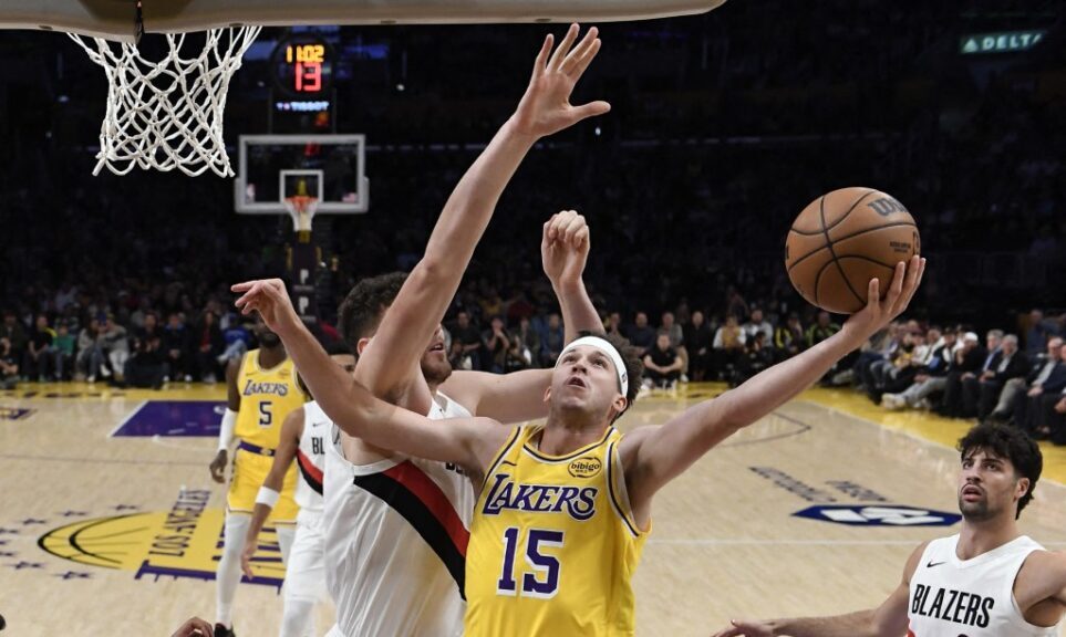 LOS ANGELES, CALIFORNIA - OCTOBER 27: Austin Reaves #15 of the Los Angeles Lakers shoots and scores against Donavan Clingan #23 of the Portland Trail Blazers during the first half at Crypto.com Arena on October 27, 2025 in Los Angeles, California. NOTE TO USER: User expressly acknowledges and agrees that, by downloading and or using this photograph, User is consenting to the terms and conditions of the Getty Images License Agreement. Kevork Djansezian/Getty Images/AFP (Photo by KEVORK DJANSEZIAN / GETTY IMAGES NORTH AMERICA / Getty Images via AFP)